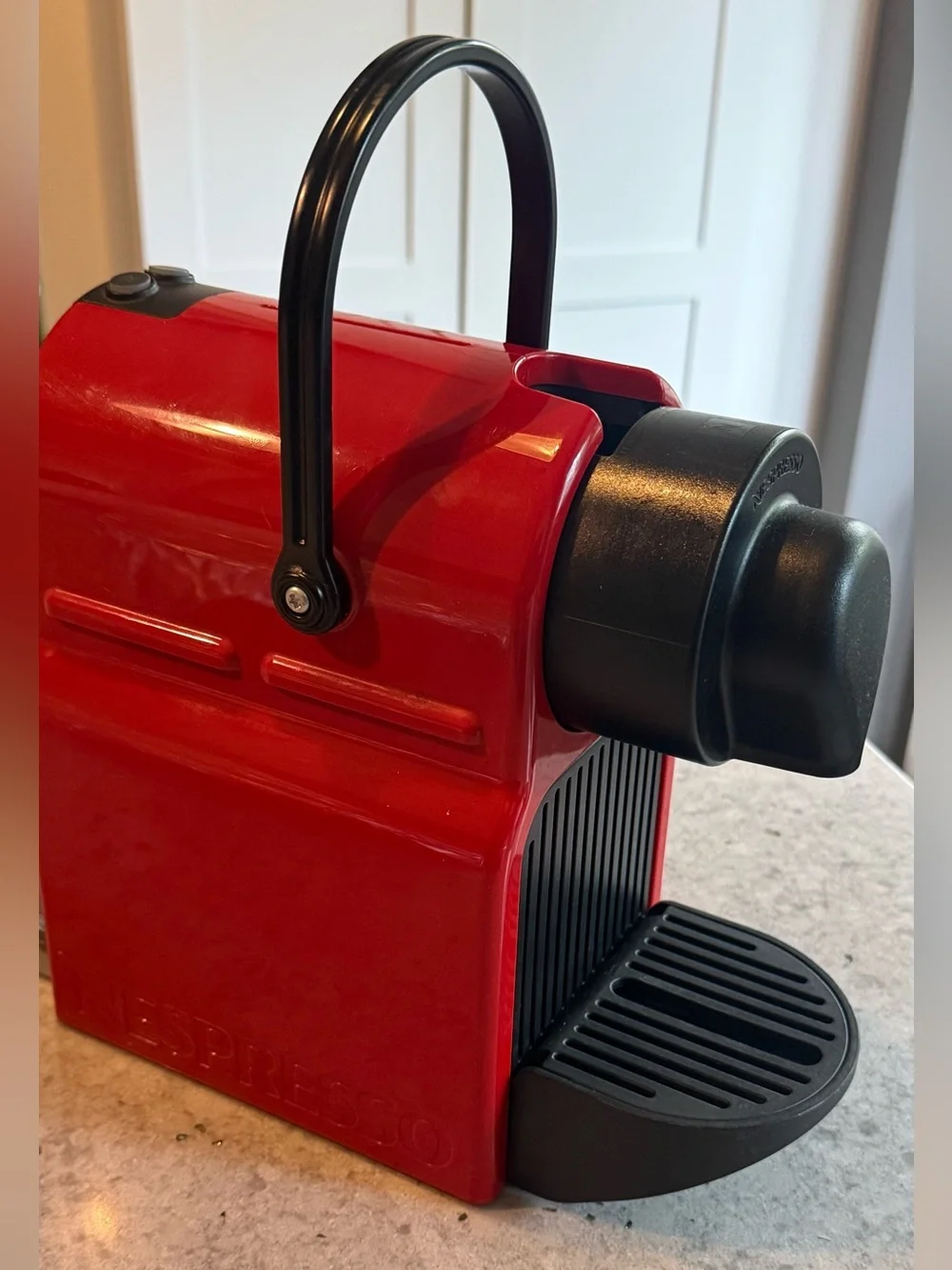 Nespresso Red Single-Serve Espresso Machine with Black Accents.